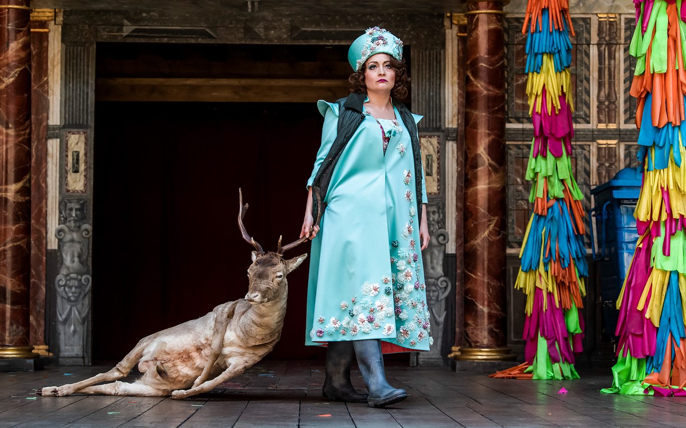 Photo of actor Victoria Elliot portraying the character Hippolyta dragging a deer carcass.